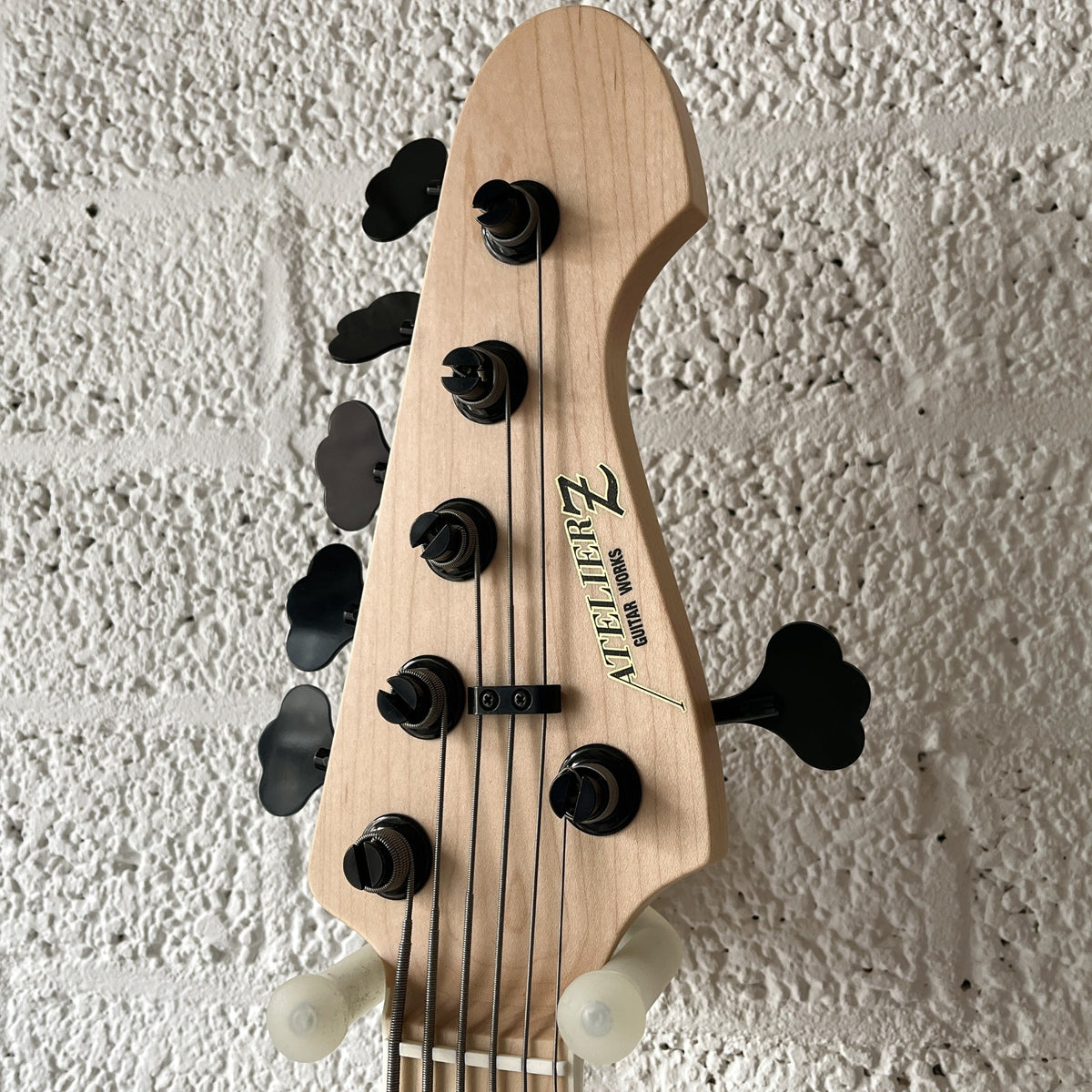 Atelier Z Beta6 6-string bass in Natural finish with black hardware body closeup headstock